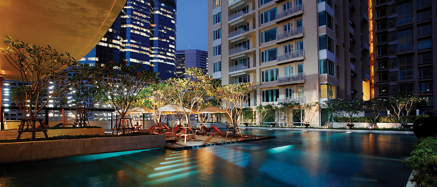 Link to deluxe condominium Marriott Vacation Club at The Empire Place in downtown Bangkok, shown at night at the pool